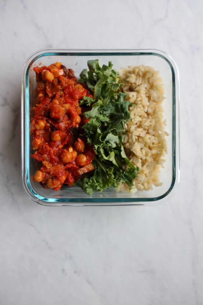 meal prep container with harissa chickpeas, kale and brown rice