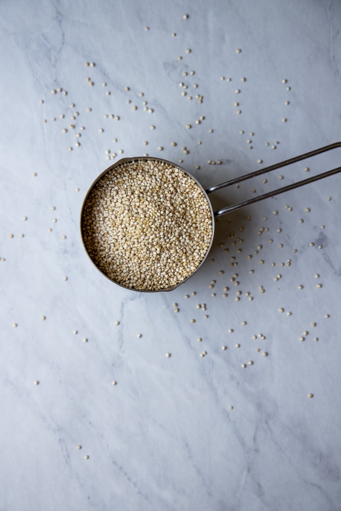 raw quinoa in a measuring cup