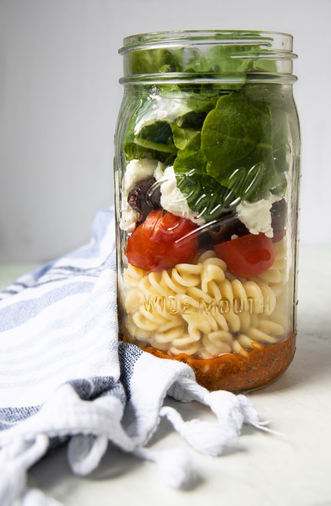 red pepper pesto salad ingredients in a mason jar