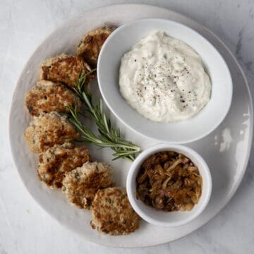 turkey slider patties on a platter with a bowl of gorgonzola mayo