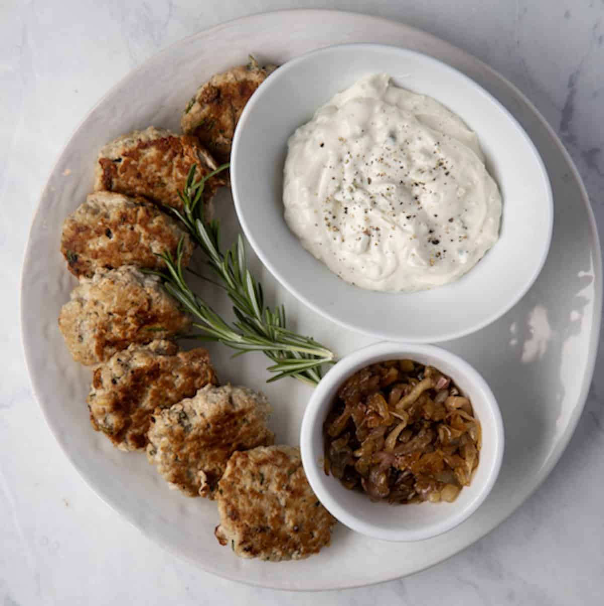 turkey slider patties on a platter with a bowl of gorgonzola mayo