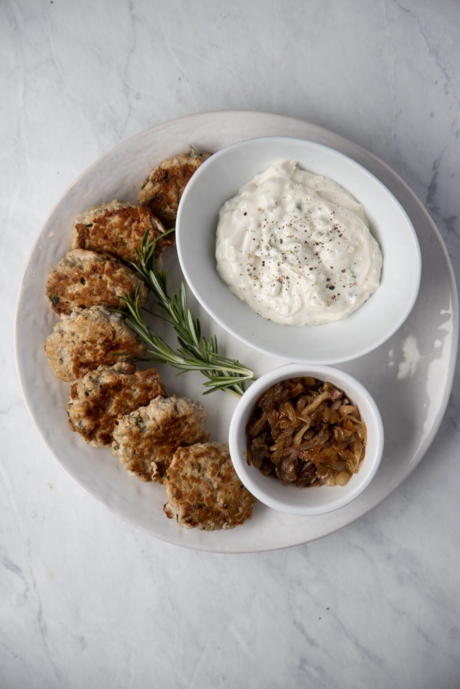 turkey sliders on a platter with caramelized onions and gorgonzola mayo