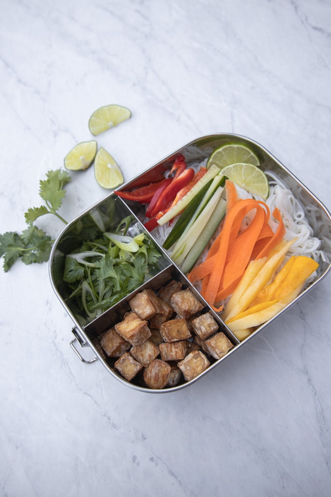 metal meal prep bento box with mango spring roll bowl inside