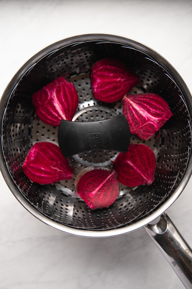 halved beets in a steamer basket