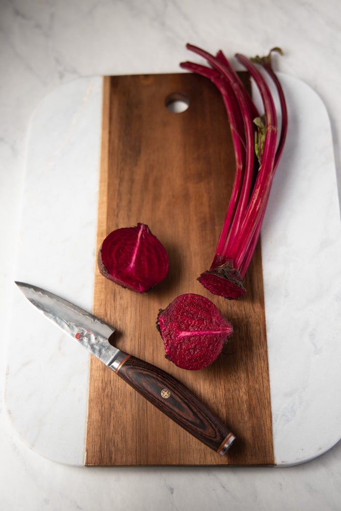 beets cut in half on a cutting board