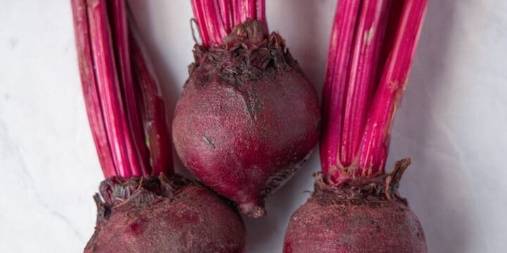 close up image of three red beets
