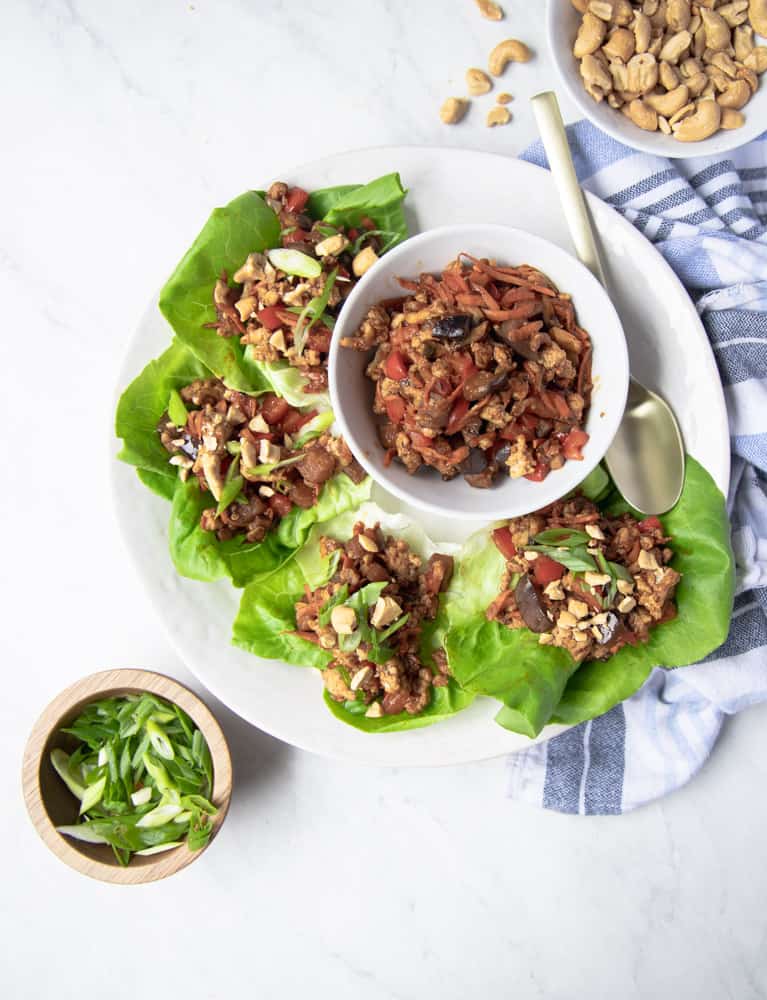 lettuce leaves stuffed with chicken mixture and displayed nicely on a white platter