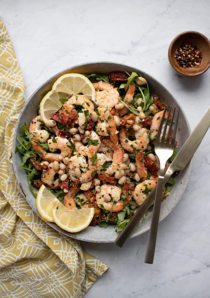 platter with arugula and shrimp and bean mixture