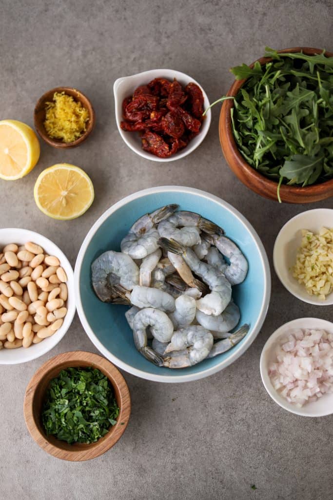 ingredients for the shrimp and bean salad in individual bowls