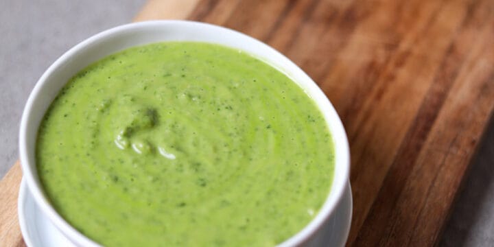 bowl of cilantro jalapeño sauce on wood cutting board