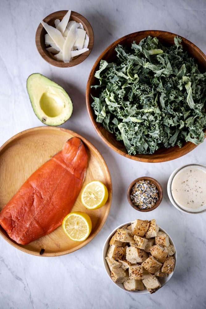 All the ingredients for the salmon Caesar salad in individual bowls
