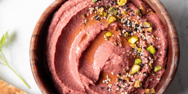 wooden bowl filled with lemon beet hummus