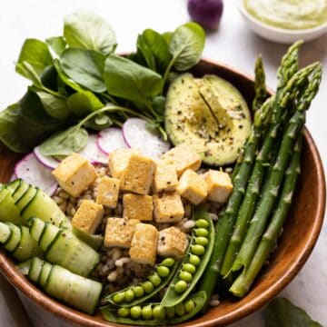 wooden bowl filled with spring grain bowl