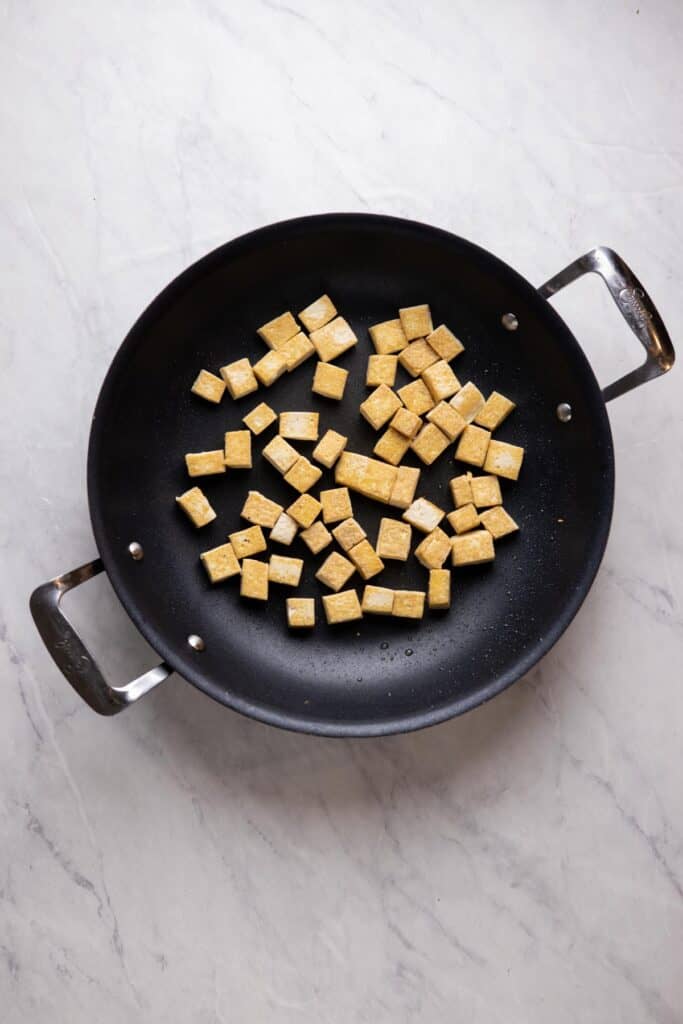 crispy tofu cubes in a skillet