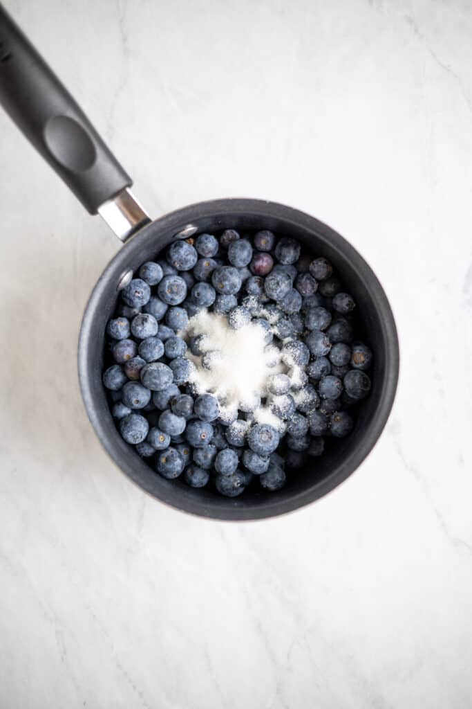 saucepot full of blueberries sprinkled with sugar
