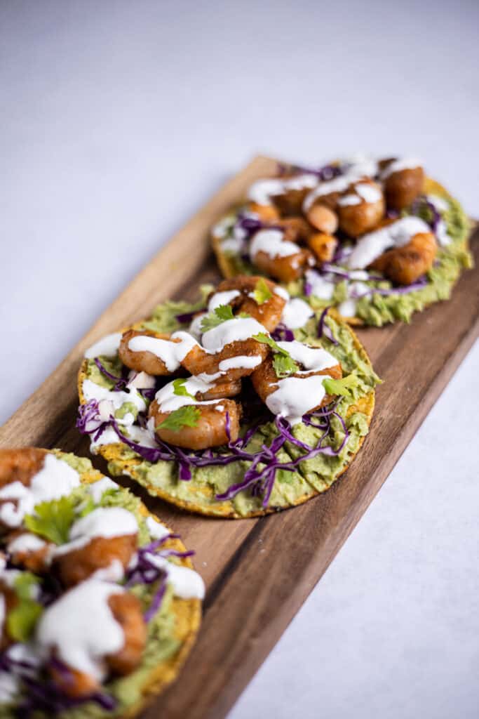 shrimp tostadas on a wood serving board