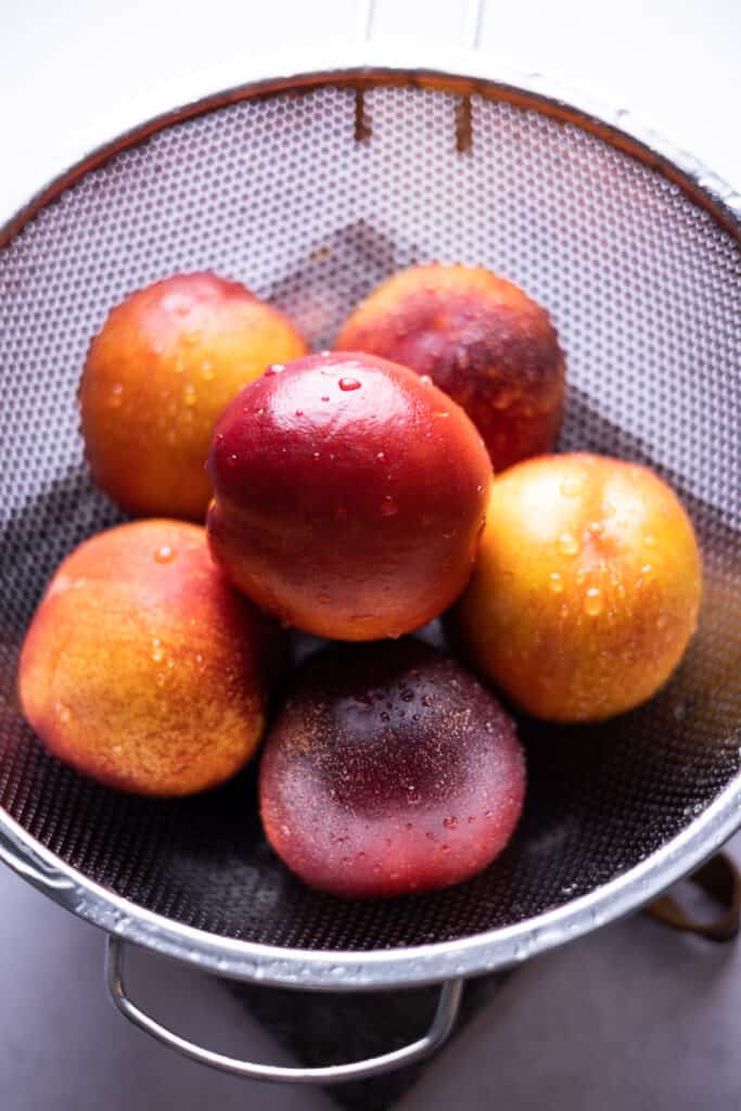 washed nectarines in a colander