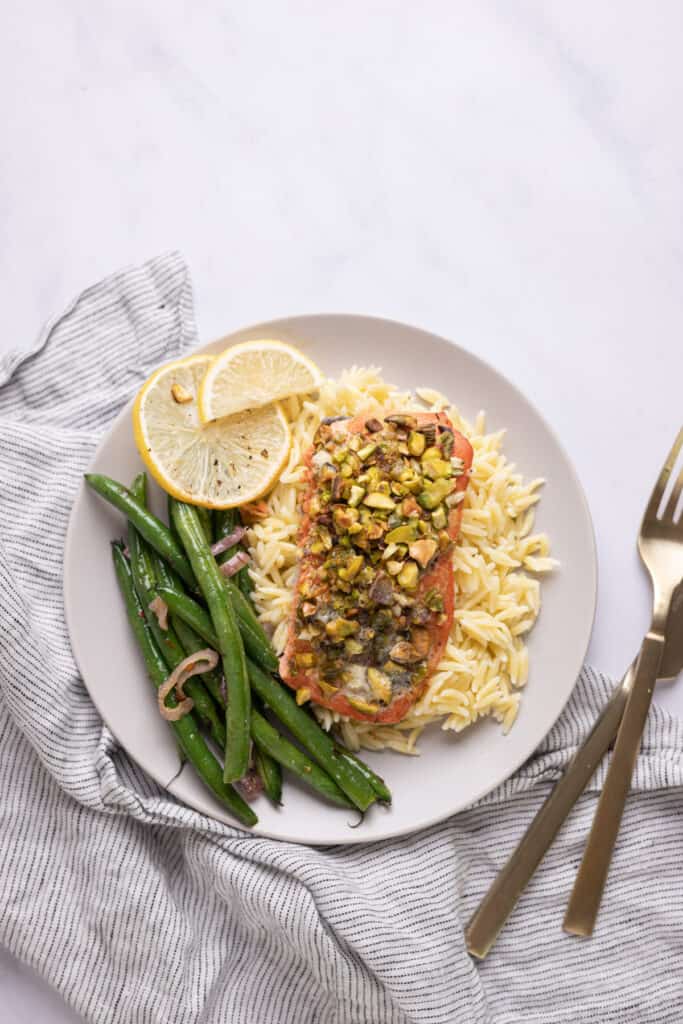 pistachio crusted salmon on a bed of orzo with green beans
