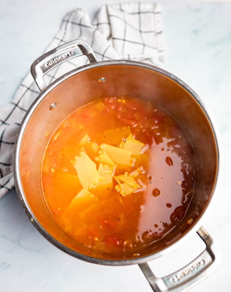Vegetarian lasagna soup in a pot with noodles added.