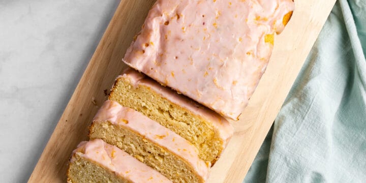 Blood orange yogurt loaf on a wooden serving tray.