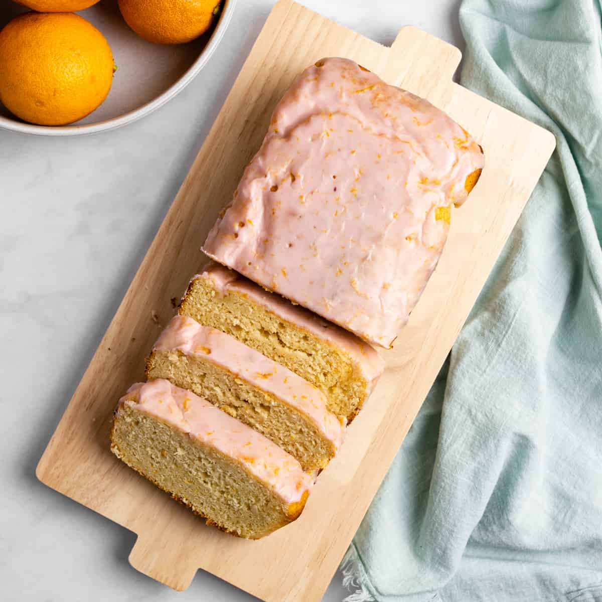 Blood orange yogurt loaf on a wooden serving tray.
