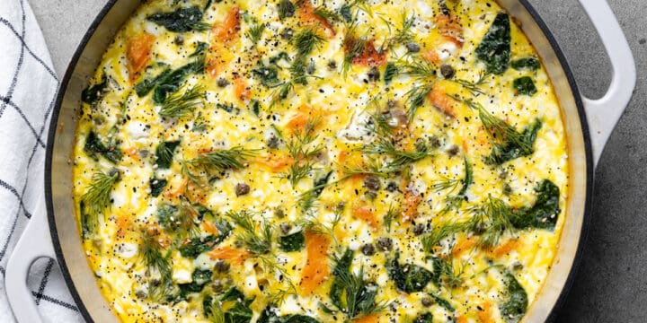 White cast iron pan with smoked salmon fritatta.
