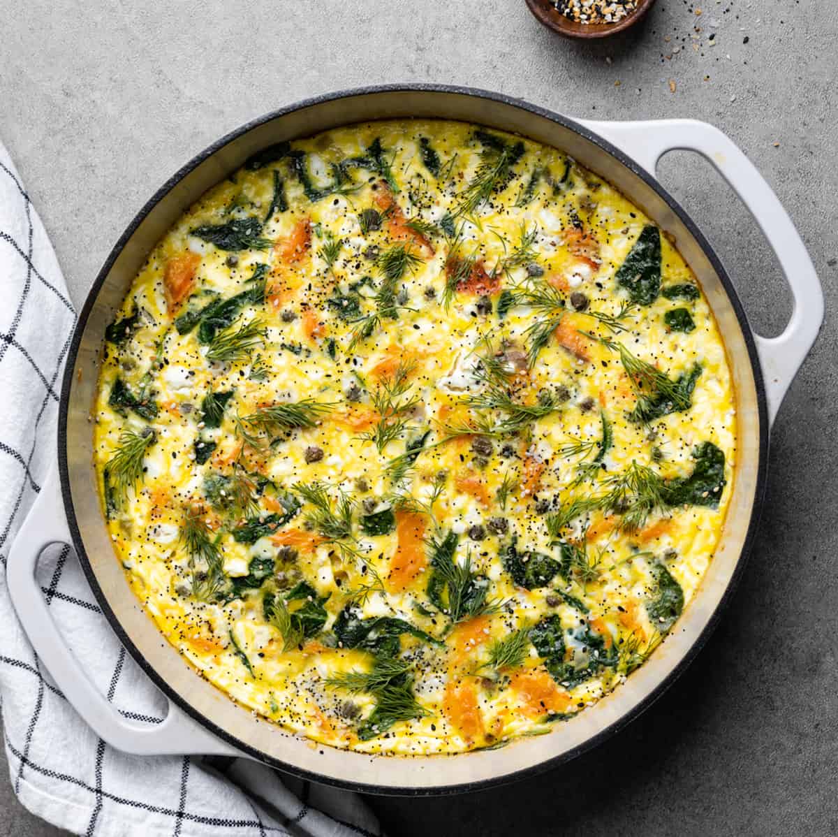 White cast iron pan with smoked salmon fritatta.