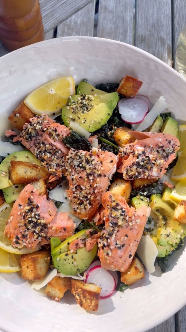 Since you can never have enough summer salad recipes in your back pocket, here’s one more for ya! 🥗My kale Caesar with addictive everything bagel croutons and flakey everything but the bagel salmon. 😮‍💨. I could honestly eat this every day! That kale makes it so hearty and store-bought Caesar dressing is your best friend for weeknight ease.  Give it a go tonight! 

#salmonrecipe #salmonrecipes #ebtb #bagelporn #summersalad #summersalads #summerrecipe #healthyrecipes #healthyrecipeideas #seafoodrecipes #weeknightdinner #weeknightmeals #weeknightcooking #saladsofinstagram #healthysalads 

1/2 lb salmon filets, bones removed
6 cups shredded kale
1 everything bagel, cubed
1 avocado, sliced
1 tbsp everything but the bagel seasoning, divided
1/3 cup caesar dressing
2 tbsp olive oil
1/3 cup shaved or shredded parmesan
1 tsp olive oil
INSTRUCTIONS
 
•Preheat oven to 400 degrees F
•Toss cubed everything bagel with 2tbsp olive oil and 2 tsp of everything but the bagel seasoning. Spread onto a sheet pan and bake for 10-12 minutes, rotating the pan and giving it a little shake halfway through.
•Bake until golden crown and crunchy throughout with no softness in the center of the cubes.
•Spread a teaspoon of olive oil onto the salmon filet. Sprinkle the remaining 1 tsp of everything but the bagel seasoning over the top of the salmon. 
•Bake at 400 degrees for 8-10 minutes or until cooked to your liking.
Depending on the thickness of your filet, 8 minutes should cook through to medium rare. To be cooked well done, it will take closer to 10-12 minutes.
•While the salmon and the croutons cook, put the shredded kale into a bowl. Drizzle over the caesar dressing and massage it into the kale using your hands.
Massage well for 1 minute and then left the kale rest for 5-10 minutes while the items in the oven finish cooking.
Assemble salad by dividing kale into two bowls. Place a salmon filet on the top of each and scatter around croutons. Shave or grate parmesan over the top. Place sliced avocado around and serve with a fresh lemon wedge.