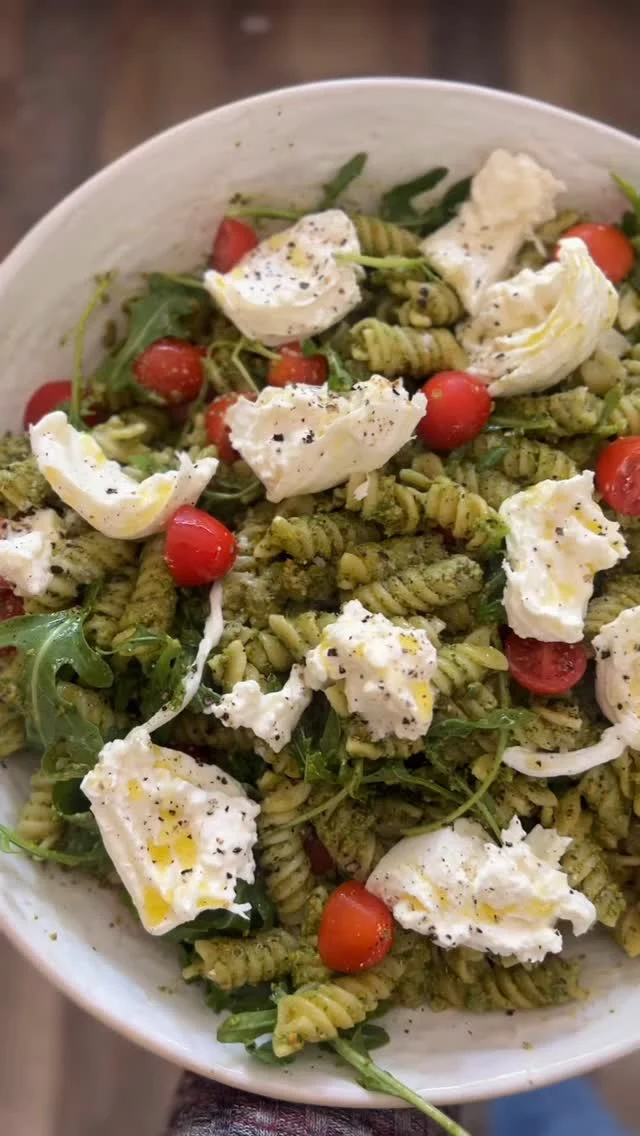 Arugula and pistachio pesto pasta salad with burrata for that time when you need an impressive cold dish to bring to a potluck, bbq or graduation party.  The pesto is worth making from scratch because the peppery arugula mixed with the buttery pistachios makes for incredible flavor.  And the food processor does all the work for you!  Keep the toppings simple with extra arugula, cherry tomatoes and creamy, dreamy burrata for a simple but elegant dish. 

Arugula Pistachio Pesto Pasta Salad
8 cups cooked pasta like rotini
1 cup cherry tomatoes, halved
2-3 balls of burrata torn into pieces
2 cups packed arugula
1 cup roasted pistachios 
2 cloves garlic, minced
1 Tbsp lemon zest
1/4 cup lemon juice (~2 lemons)
1/2 cup grated parmesan
pinch red pepper flakes
1/2 tsp flaky sea salt or 1/4 tsp kosher salt
1 cup spinach
6T extra virgin olive oil

Combine the arugula, pustachios, garlic, lemon zest, lemon juice, parm, red peoper flakes, and salt in a food processor and pulse a few times to combine. Drizzle in the olive oil with the motor running. If it looks a little brown from the pistachios you can add a cup of spinach and blend until smooth-ish. Toss with your cooked pasta and cherry tomatoes. Top with torn burrata and extra arugula. Drizzle with evoo and top with cracked black pepper and flaky salt.

#pastasalad #pestopasta #pestosauce #pastaporn #sidedish #sidedishes #fancywithoutthefuss #potluck #summerrecipes #summerrecipe #burratacheese #burrata